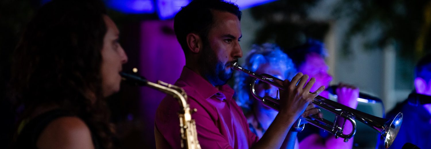 Close up of band trumpet and saxophonist players in a club