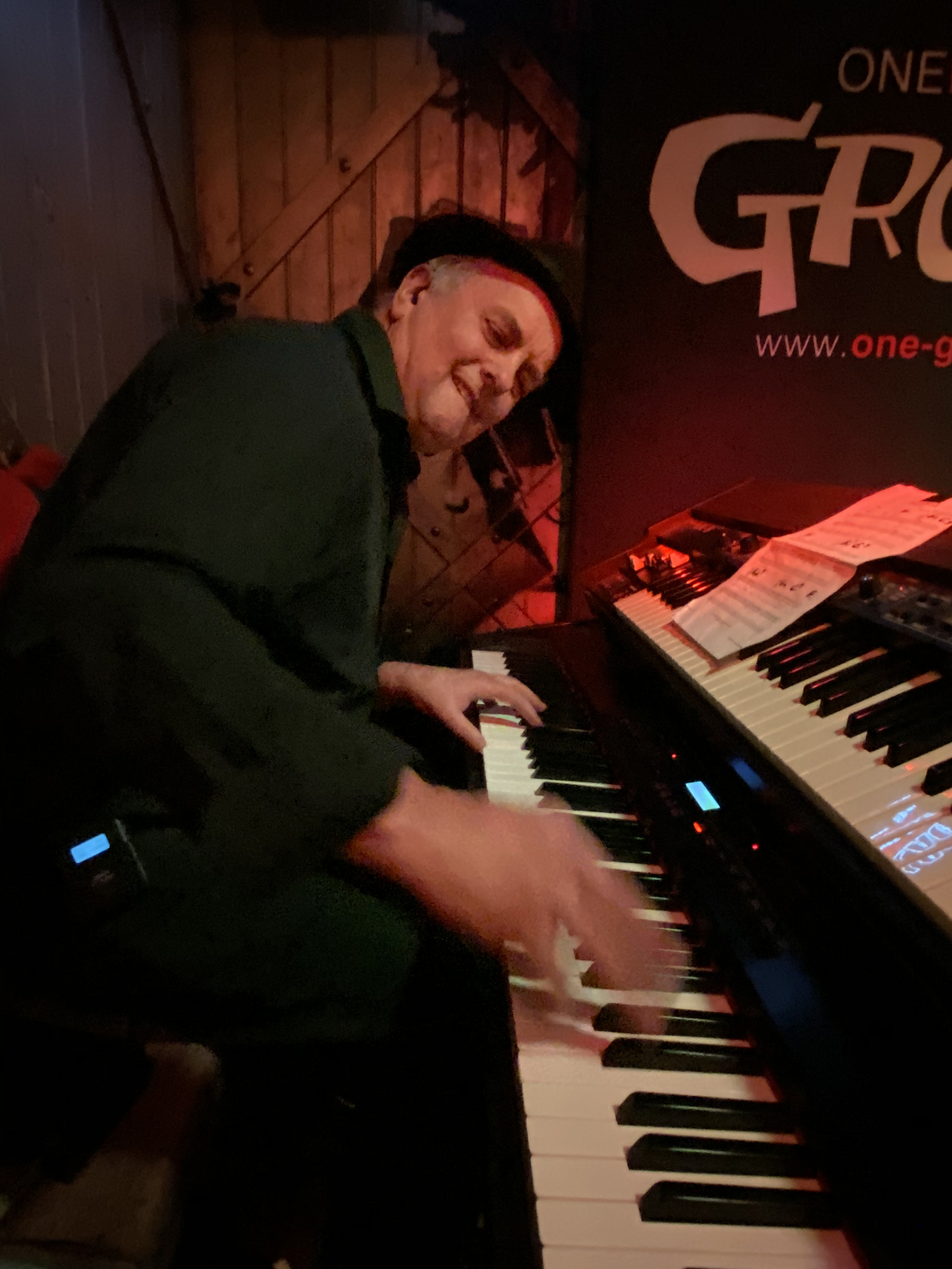 Band members plays keyboards on nightclub stage