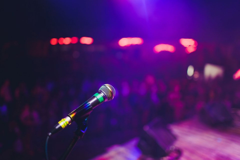 Microphone stand in darkened nightclub