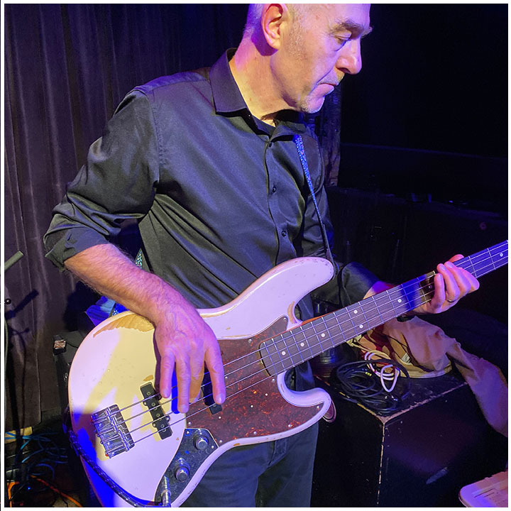 Band member playing bass guitar